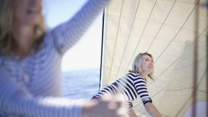 two-women-adjusting-boat-sails