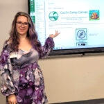 Julie Eller standing in front of screen where her instructional design content is projected.