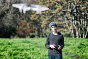 Adolescent boy flying a toy drone quadcopter