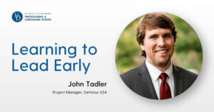Header image featuring the University of Delaware Professional & Continuing Studies logo at top left, a large blue headline reading “Learning to Lead Early,” and below it the name “John Tadler” with the subtitle “Project Manager, Sartorius USA.” On the right side, a circular portrait shows a person in a suit and tie against a softly blurred green outdoor background.